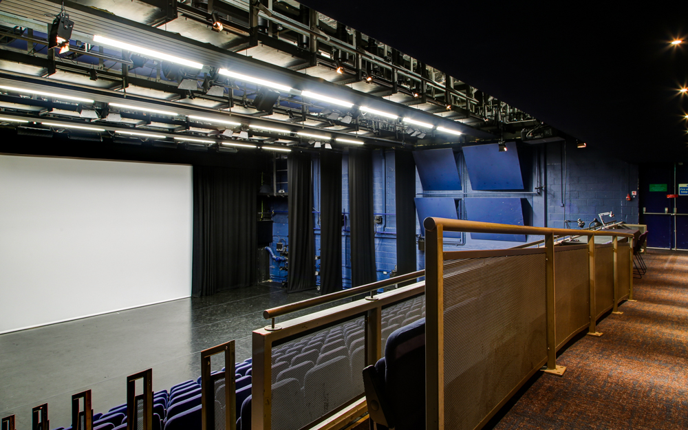 Lilian Baylis Studio stage with projection screen for conferences and performances.