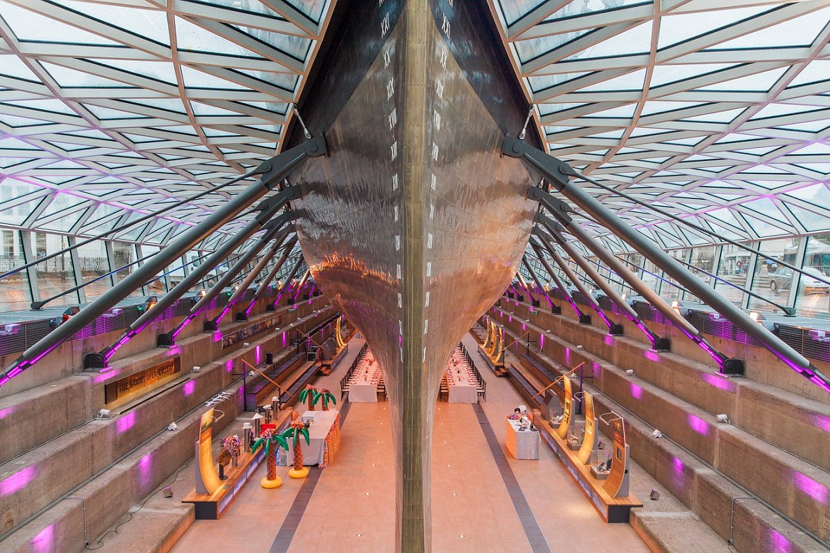 Dry Berth at Cutty Sark: striking ship hull venue with purple lighting for events.