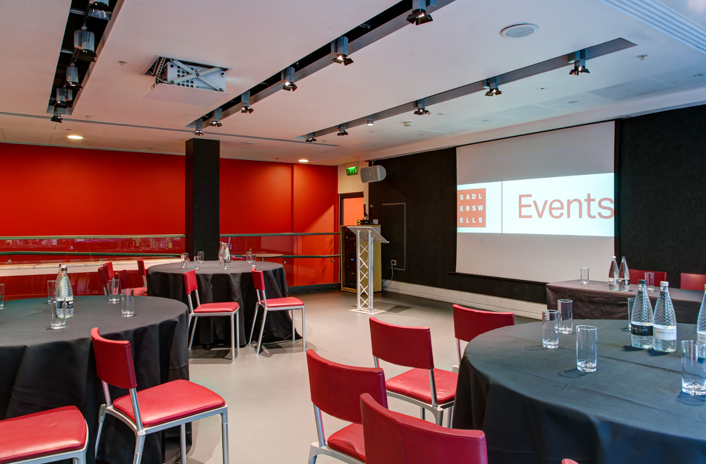 Dorfman Room at Sadler's Wells: modern event space with round tables for meetings and social events.