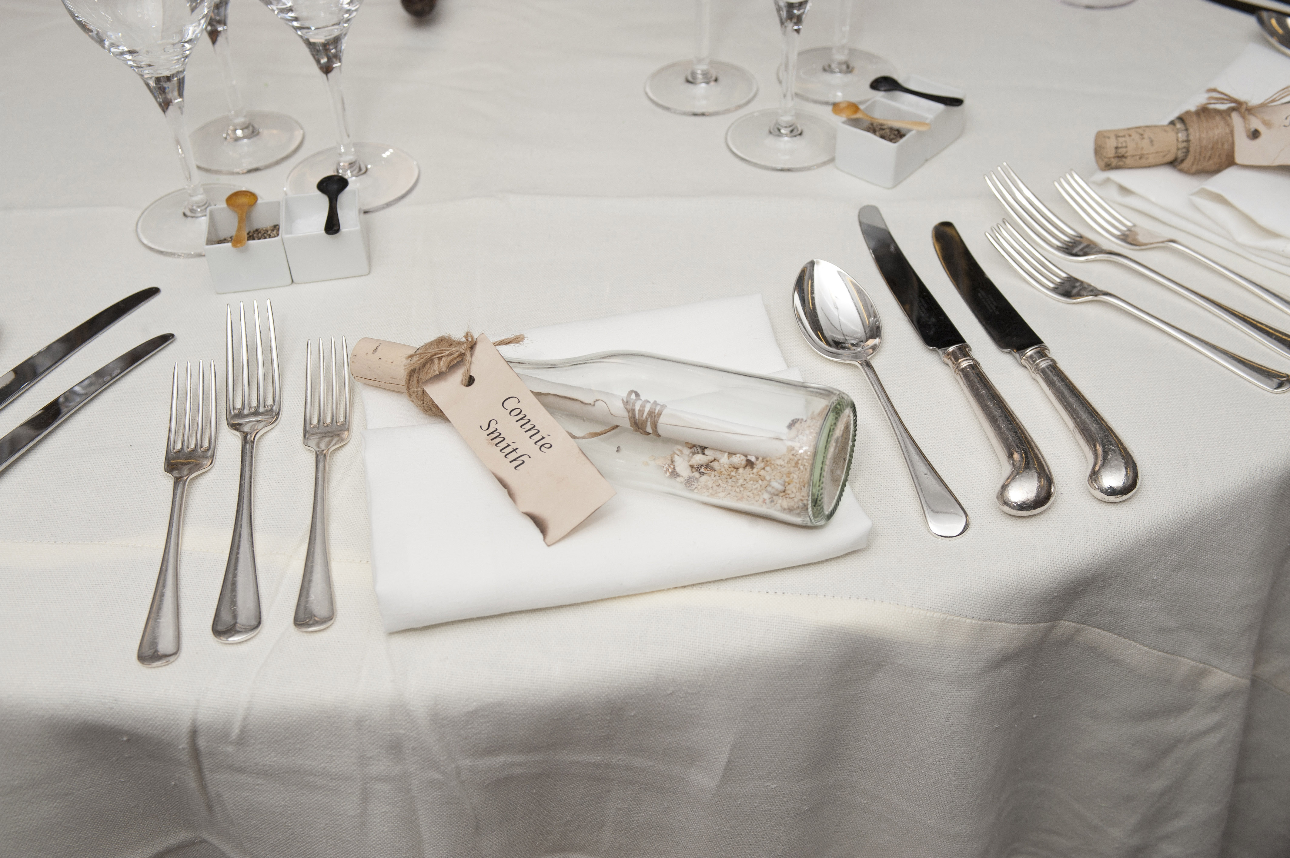Elegant dining table on Cutty Sark with message in a bottle for upscale events.