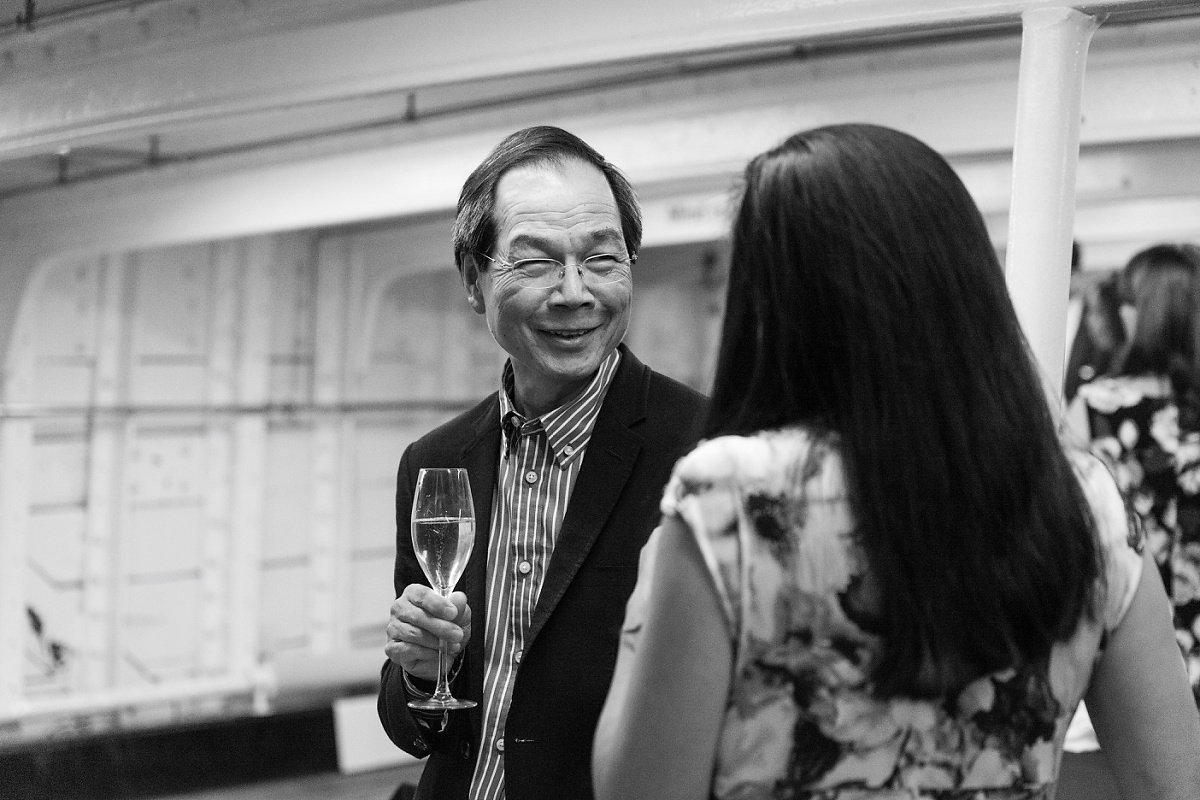 Gentleman networking with champagne flute at upscale Cutty Sark event.
