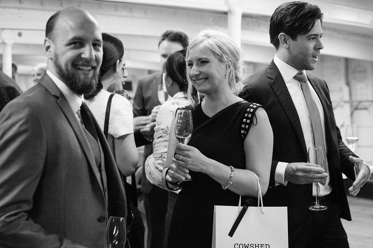 Networking event on Tween Deck, Cutty Sark; elegant attire, vibrant atmosphere.