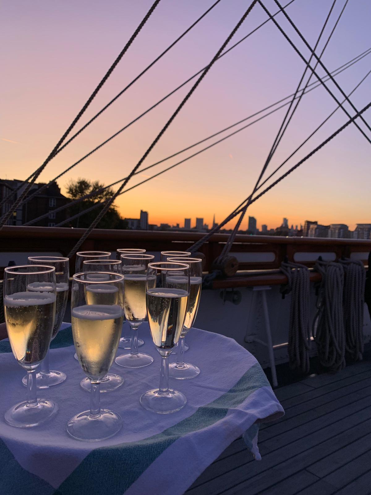 "Masters Saloon sunset with champagne flutes, perfect for upscale events in Cutty Sark."