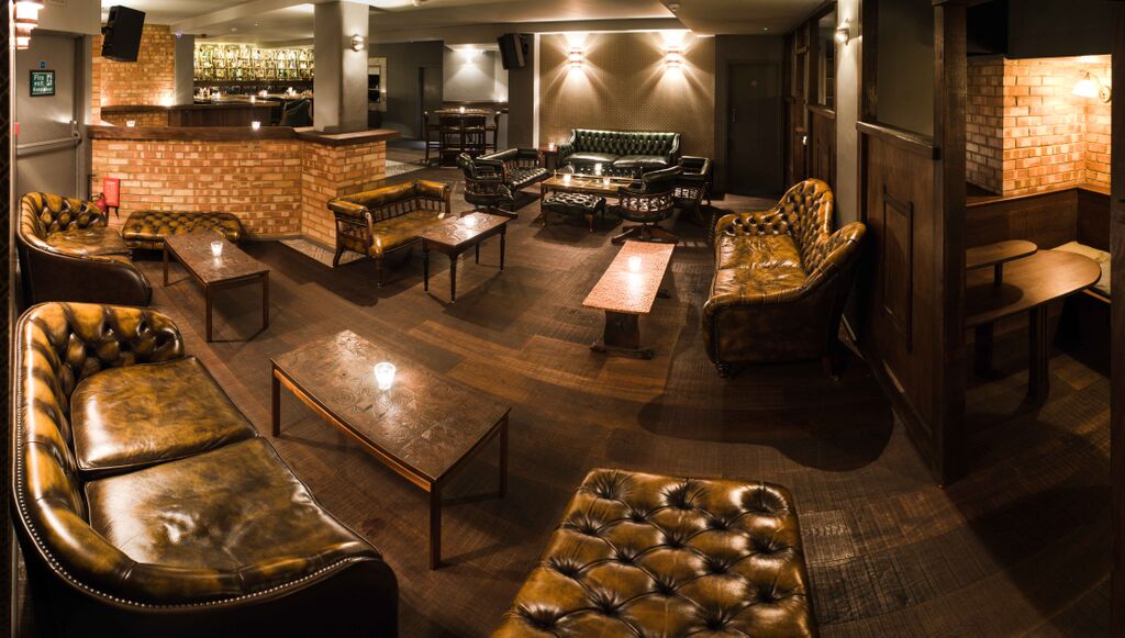 Intimate lounge at Basement Sate for networking events with cozy seating and warm lighting.