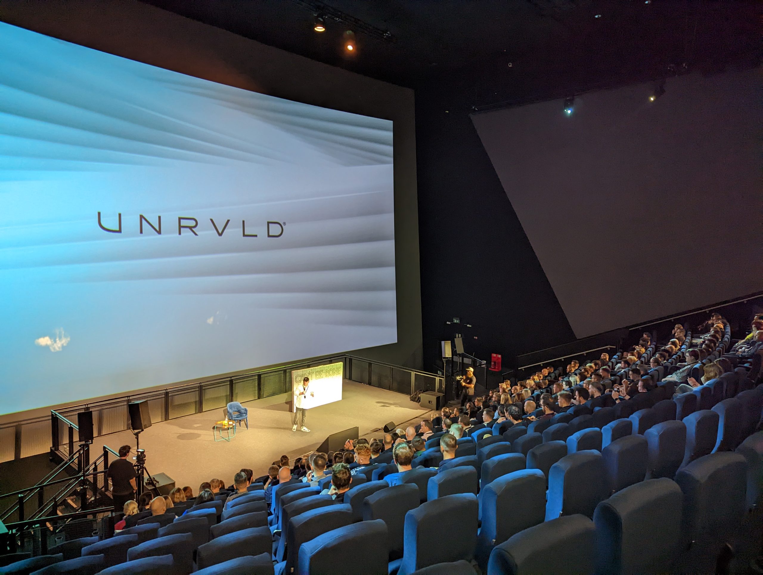 IMAX Theatre event with large screen, engaged audience, professional presentation.