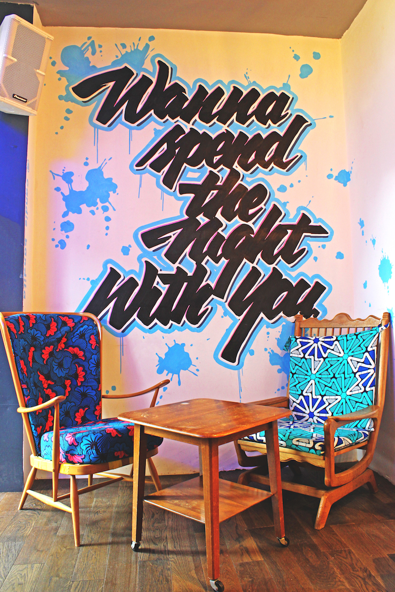 Vibrant lounge area with bold mural, perfect for networking events and casual gatherings.