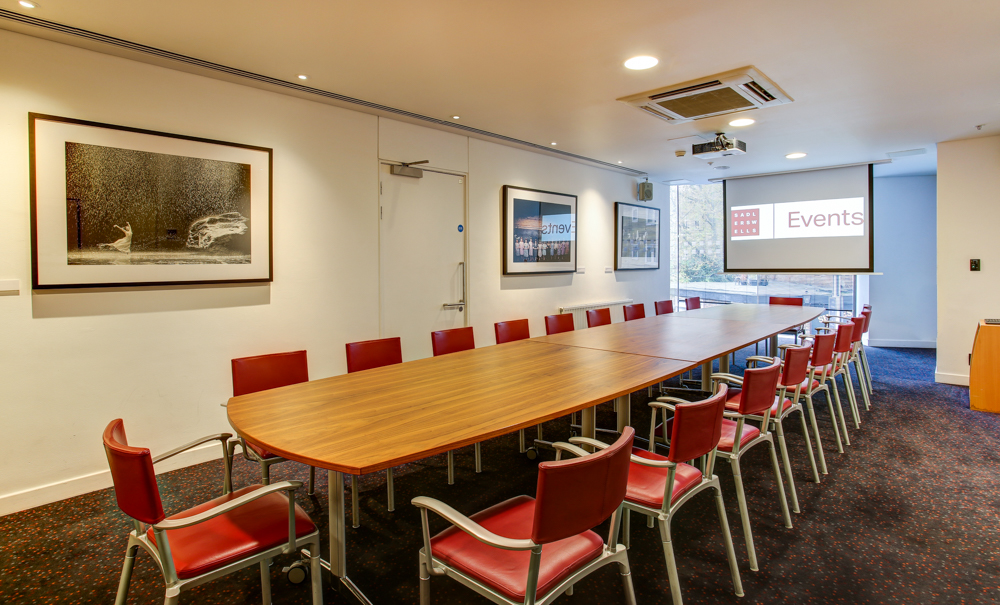 Pina Bausch Room at Sadler's Wells: modern meeting space with red chairs for events.