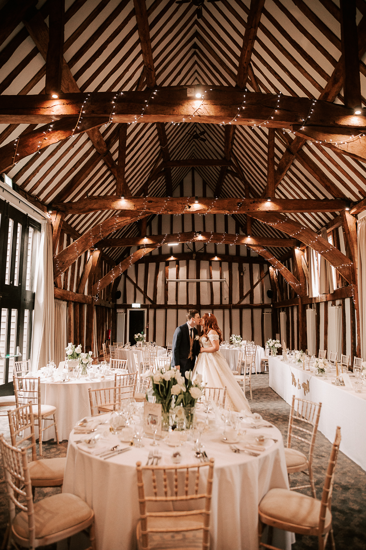 Manor Barn at Knebworth House: rustic wedding venue with elegant decor and warm lighting.