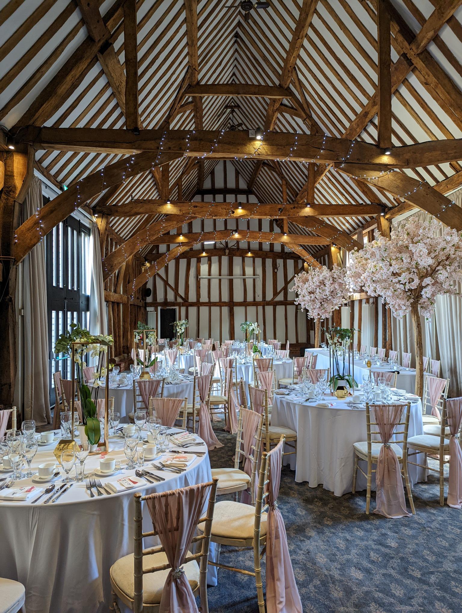 Elegant Manor Barn event space with floral centerpieces, ideal for weddings and upscale gatherings.