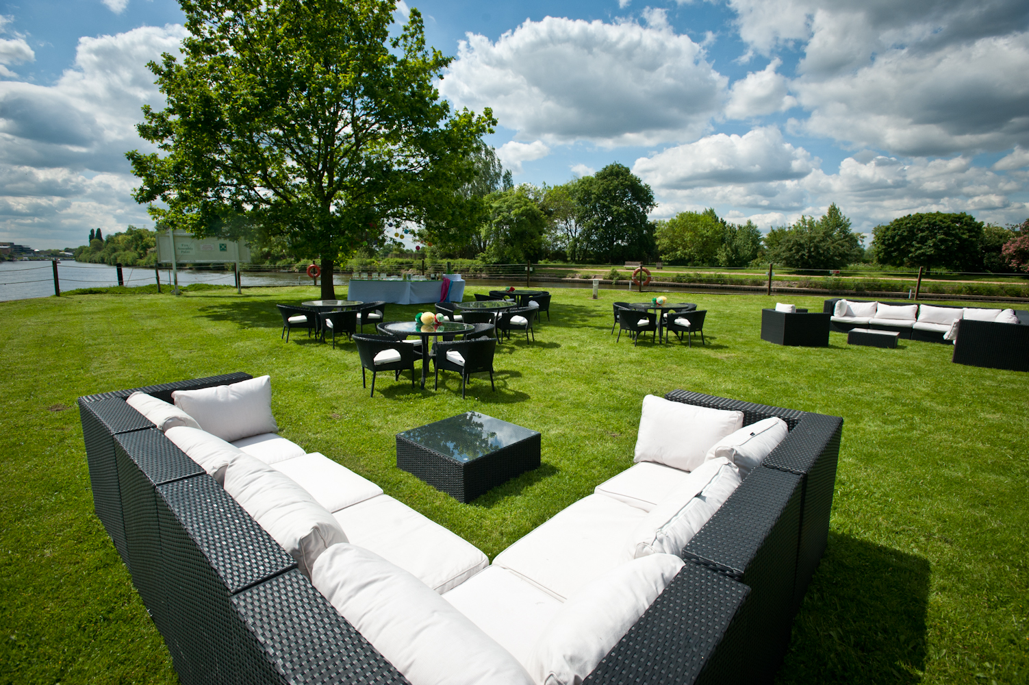 Outdoor event space on Ravens Ait Island with lounge seating and scenic water view.