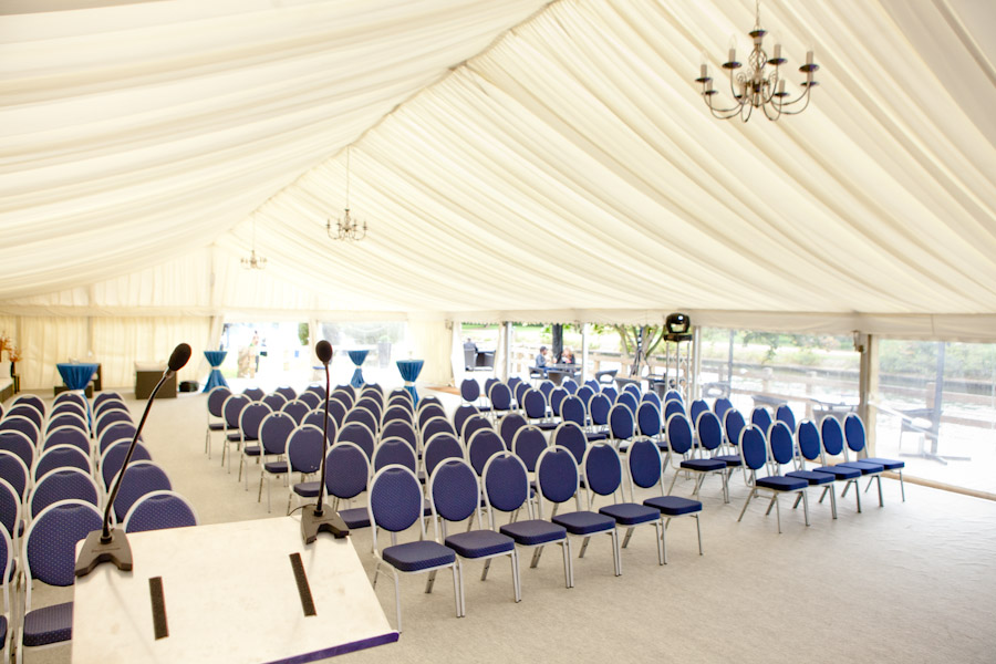 Spacious marquee with blue chairs for conferences on Ravens Ait Island.
