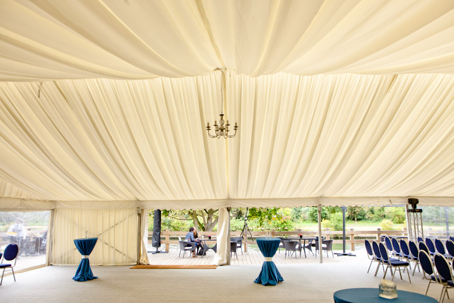 Elegant marquee with chandelier on Ravens Ait Island for events and receptions.