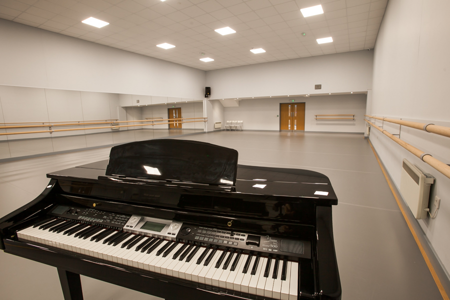 Van Laast Studio with black piano, ideal for dance and music events.