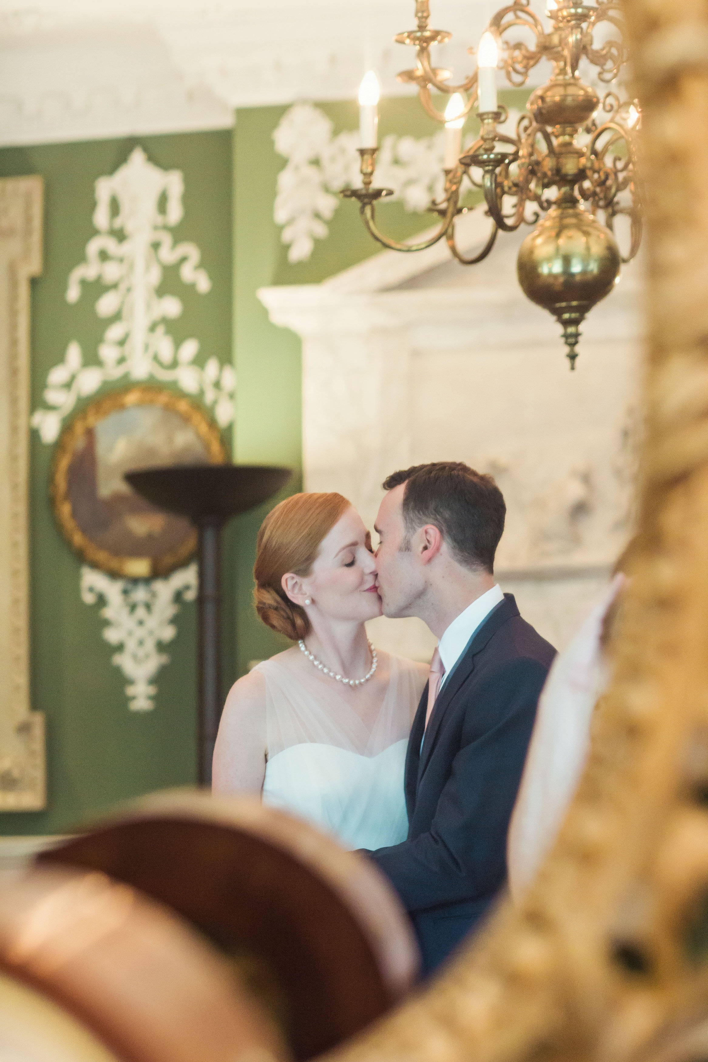Intimate wedding moment in elegant Foundling Museum court room setting.