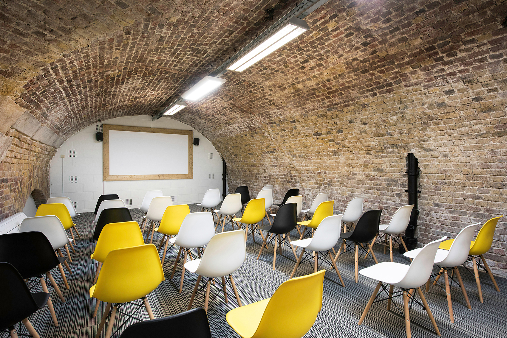 Kennedy in The Dock: rustic brick archway, flexible seating for events and workshops.