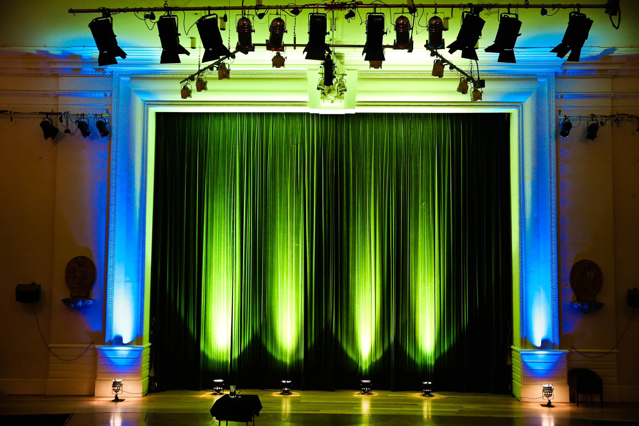Memorial Hall stage with vibrant lighting, perfect for presentations and performances.