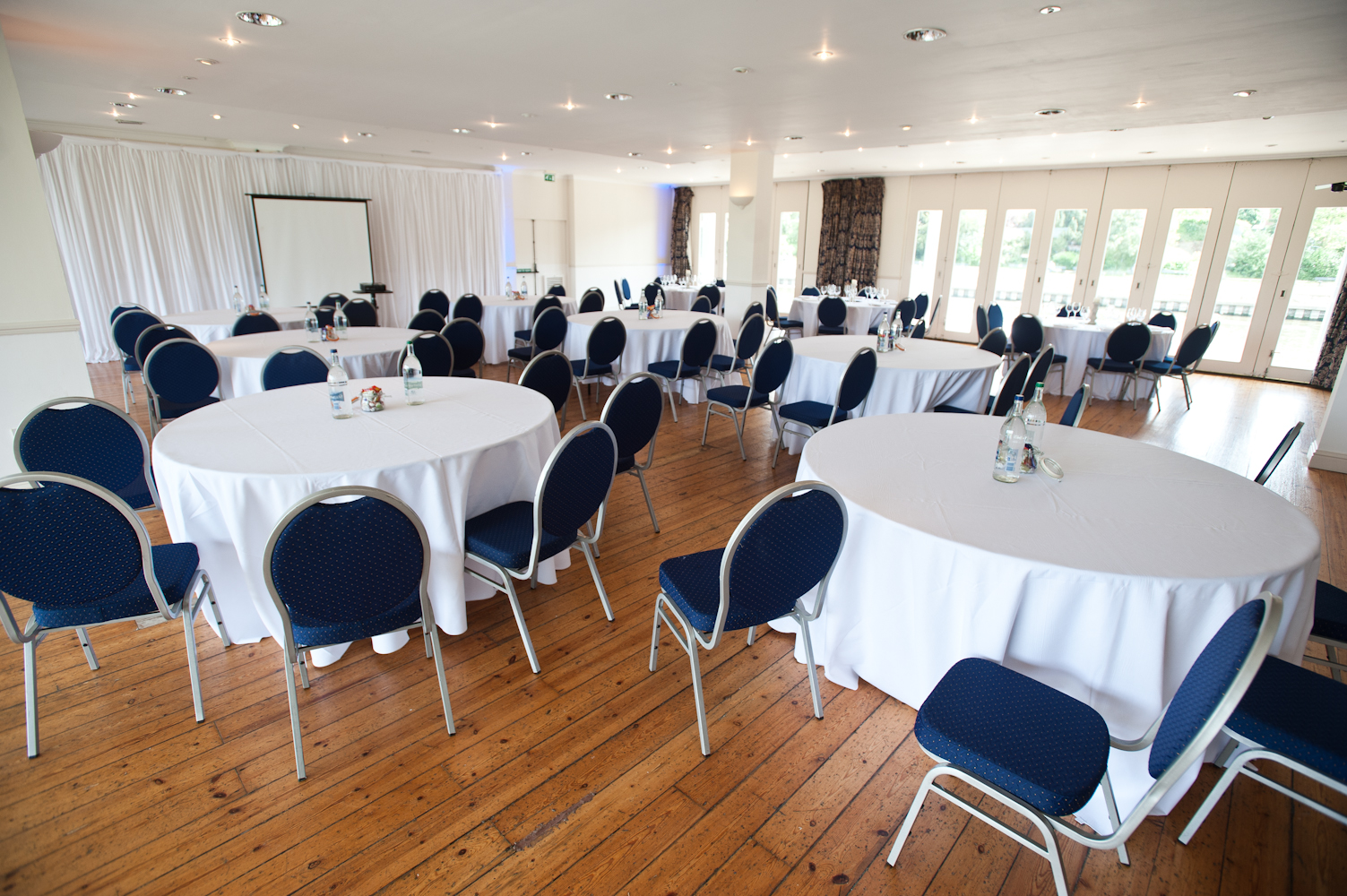 Britannia Suite event space with round tables, ideal for meetings and gatherings.