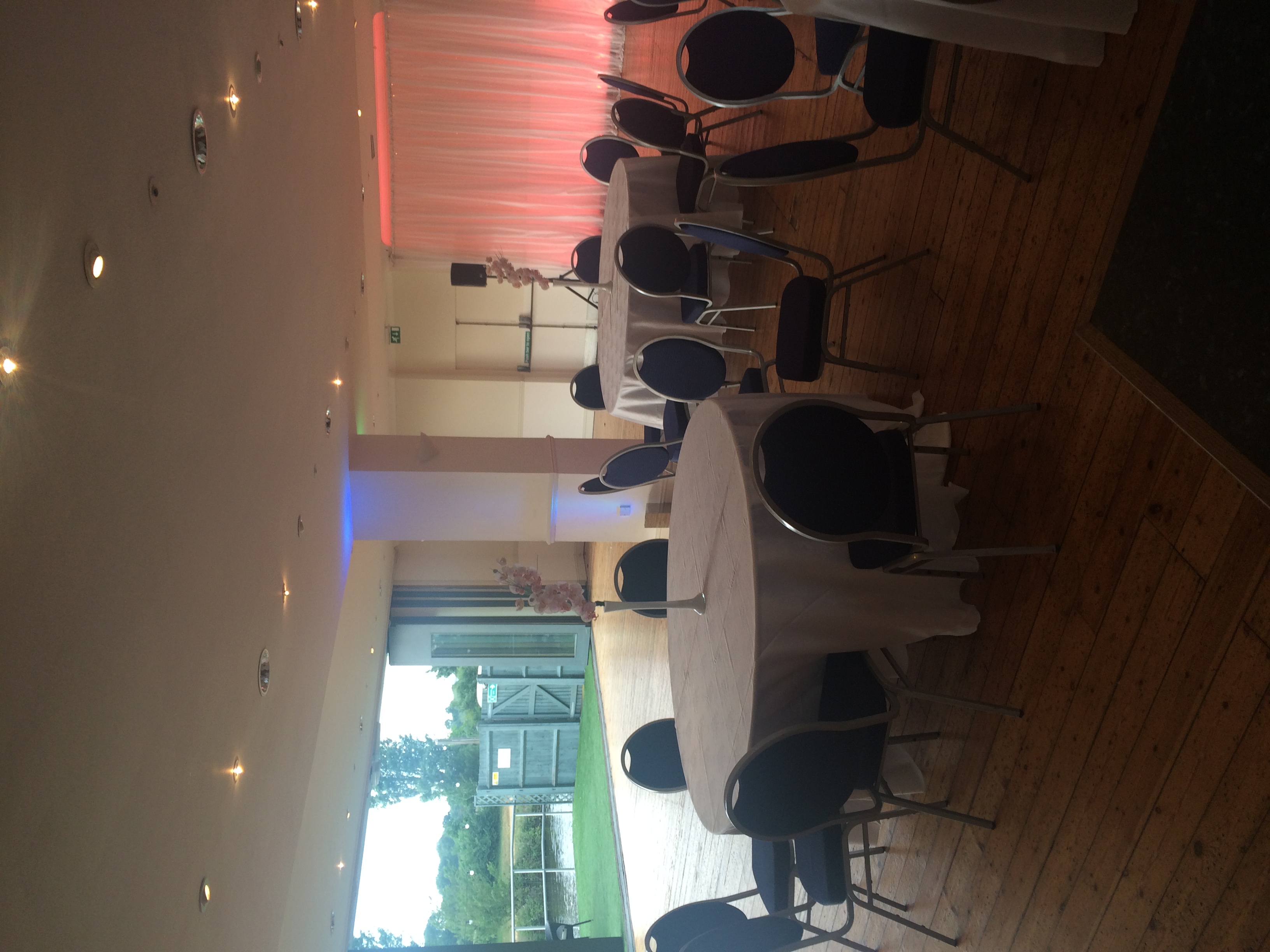 Britannia Suite event space with round tables, elegant decor, and natural light.