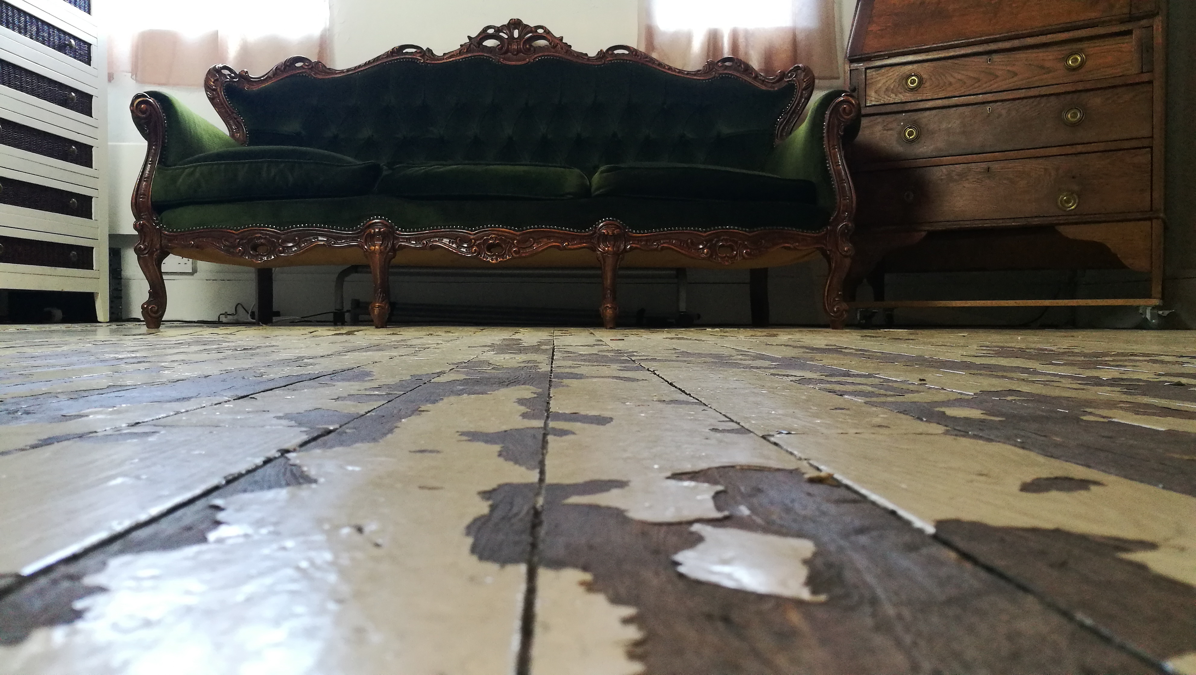 Vintage green velvet couch in Dalston Popup Loft for intimate gatherings and events.