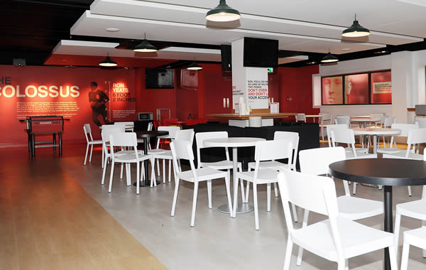 Shanks Lounge at Liverpool FC: modern event space with red accents for meetings and gatherings.