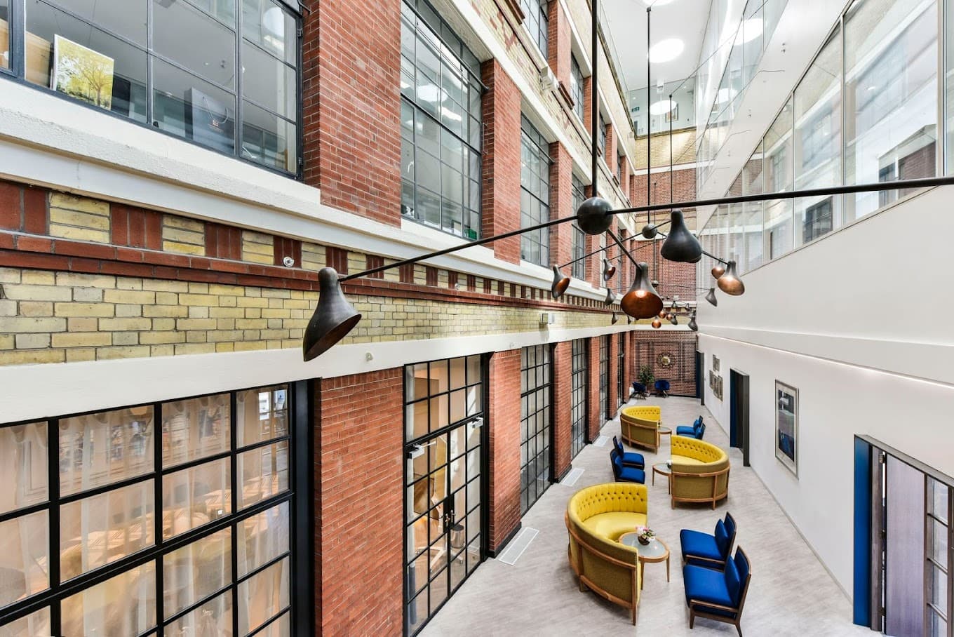 Industrial-chic breakout space with modular seating for networking events and professional meetings.