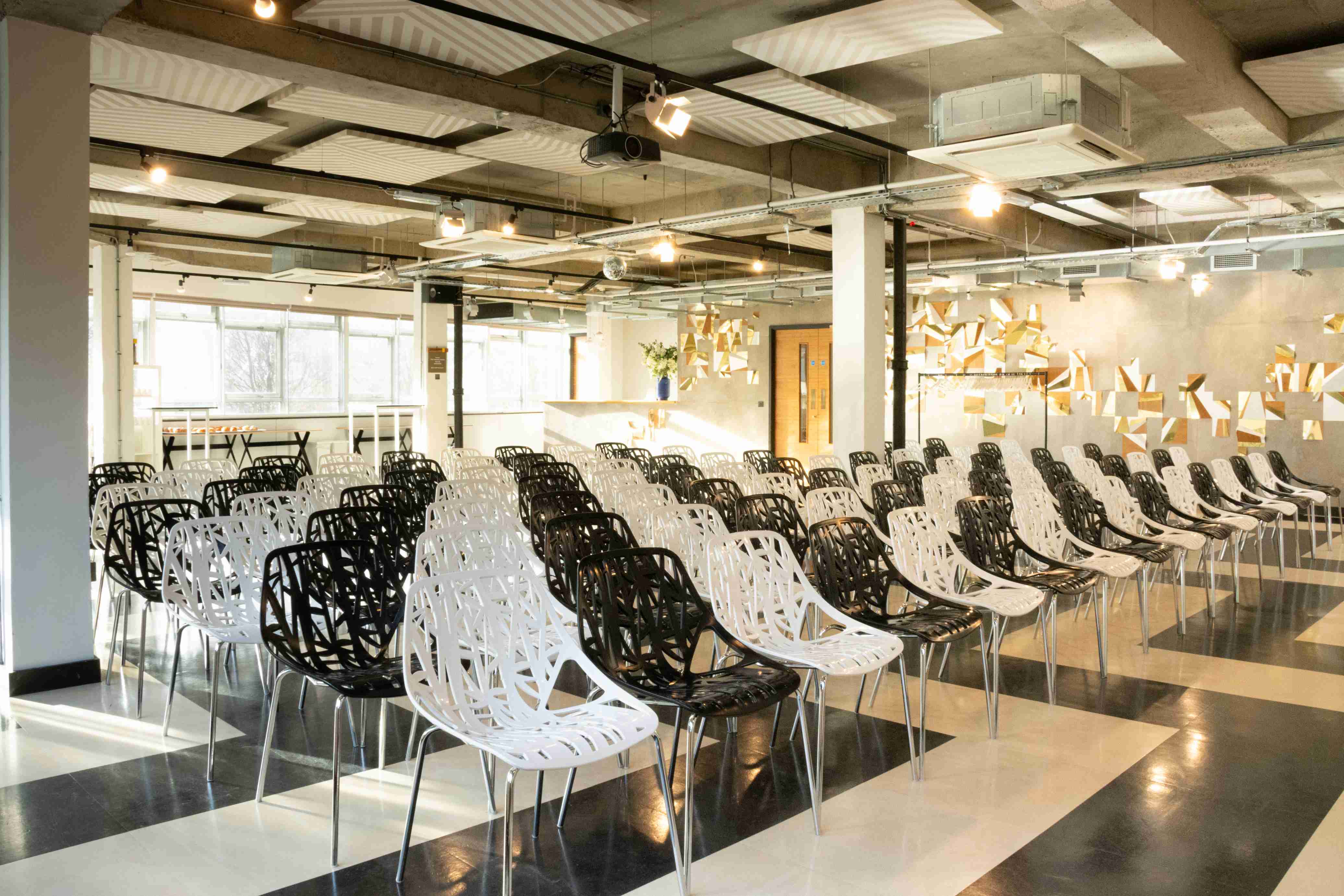 Modern event space with black and white chairs for presentations at The Trampery Old Street.