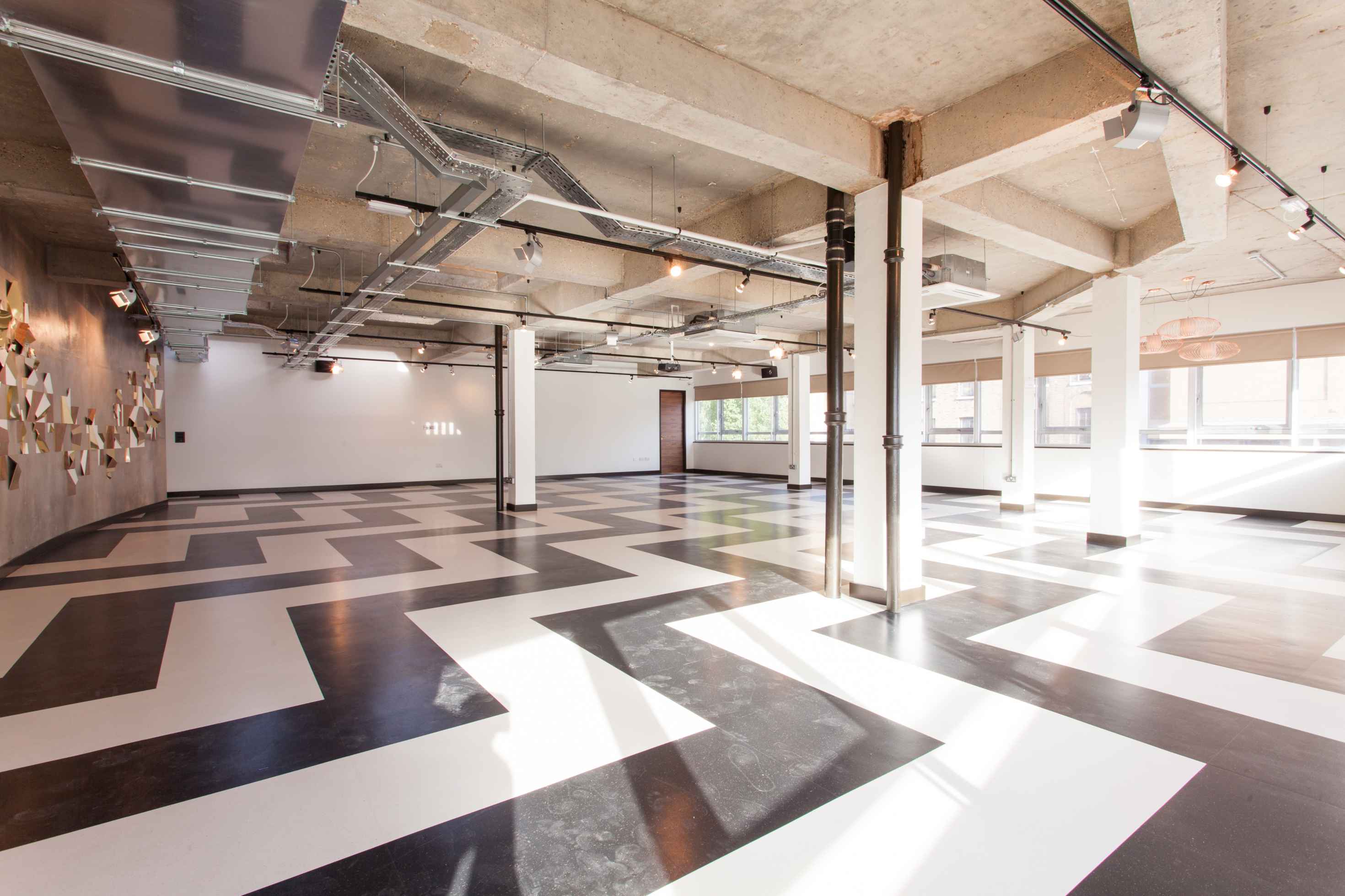 Modern industrial event space with chevron flooring at The Trampery Old Street.