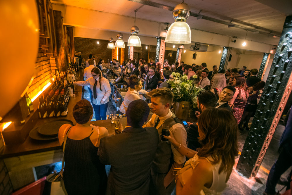 Vibrant networking event at The Bays, Victoria Warehouse with modern decor and warm lighting.