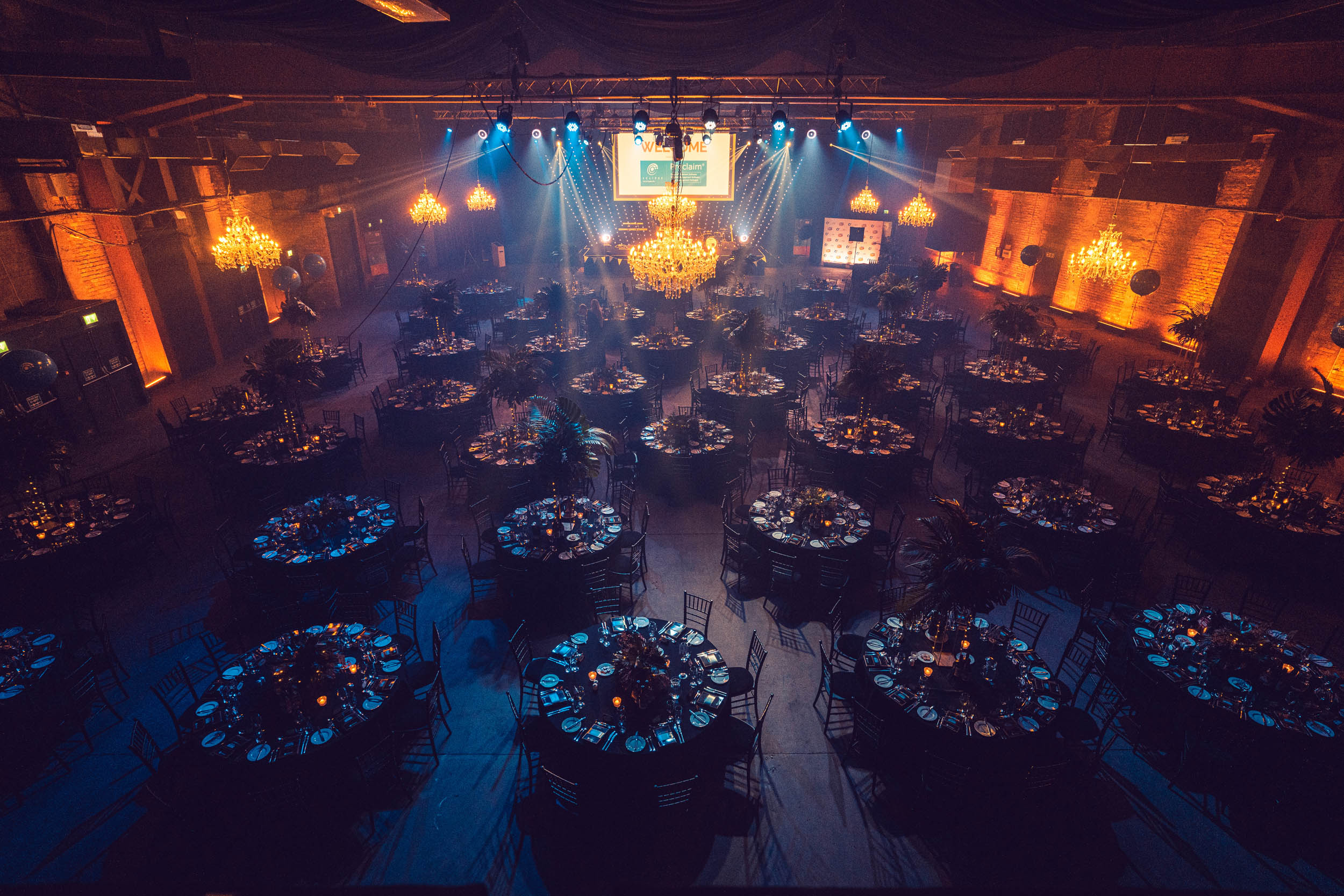 Elegant event space at Victoria Warehouse with round tables for corporate galas.