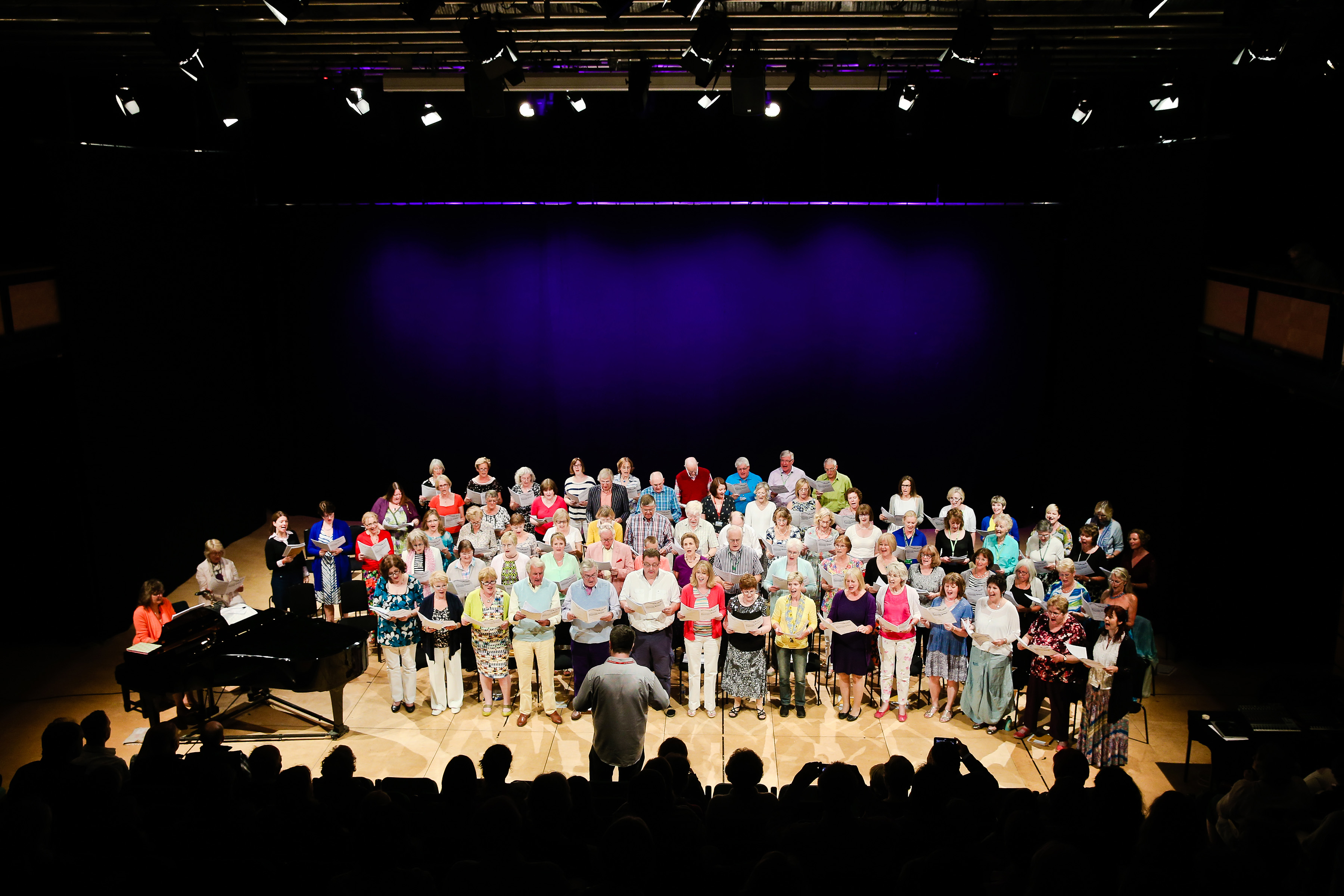 Choir performance at The Ellis Theatre, showcasing vibrant lighting and acoustics.