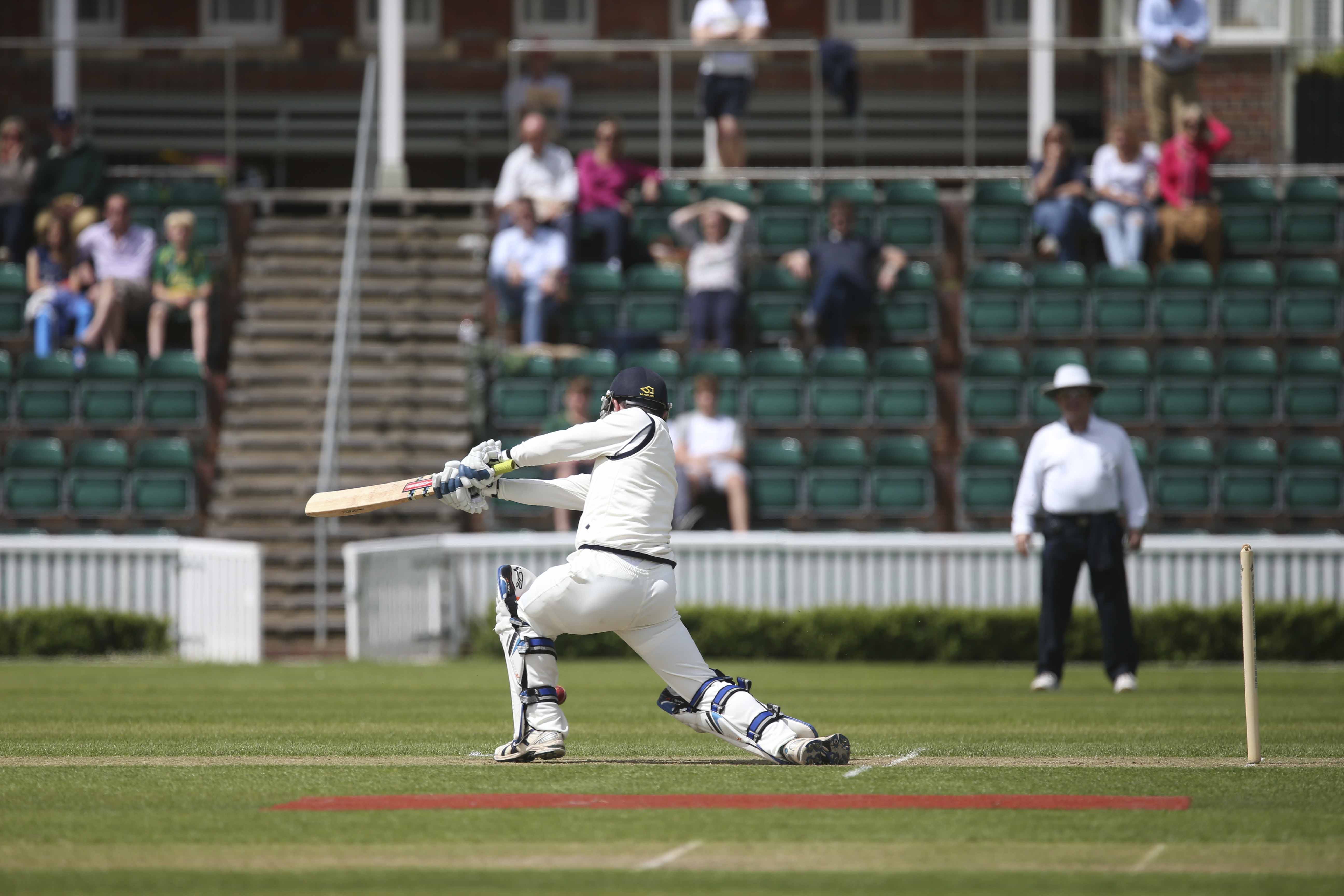 Cricket Pavilion at Marlborough College during a lively cricket match, perfect for events.
