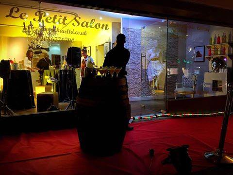 Elegant outdoor event setup at Le Petit Salon with unique barrel tables.