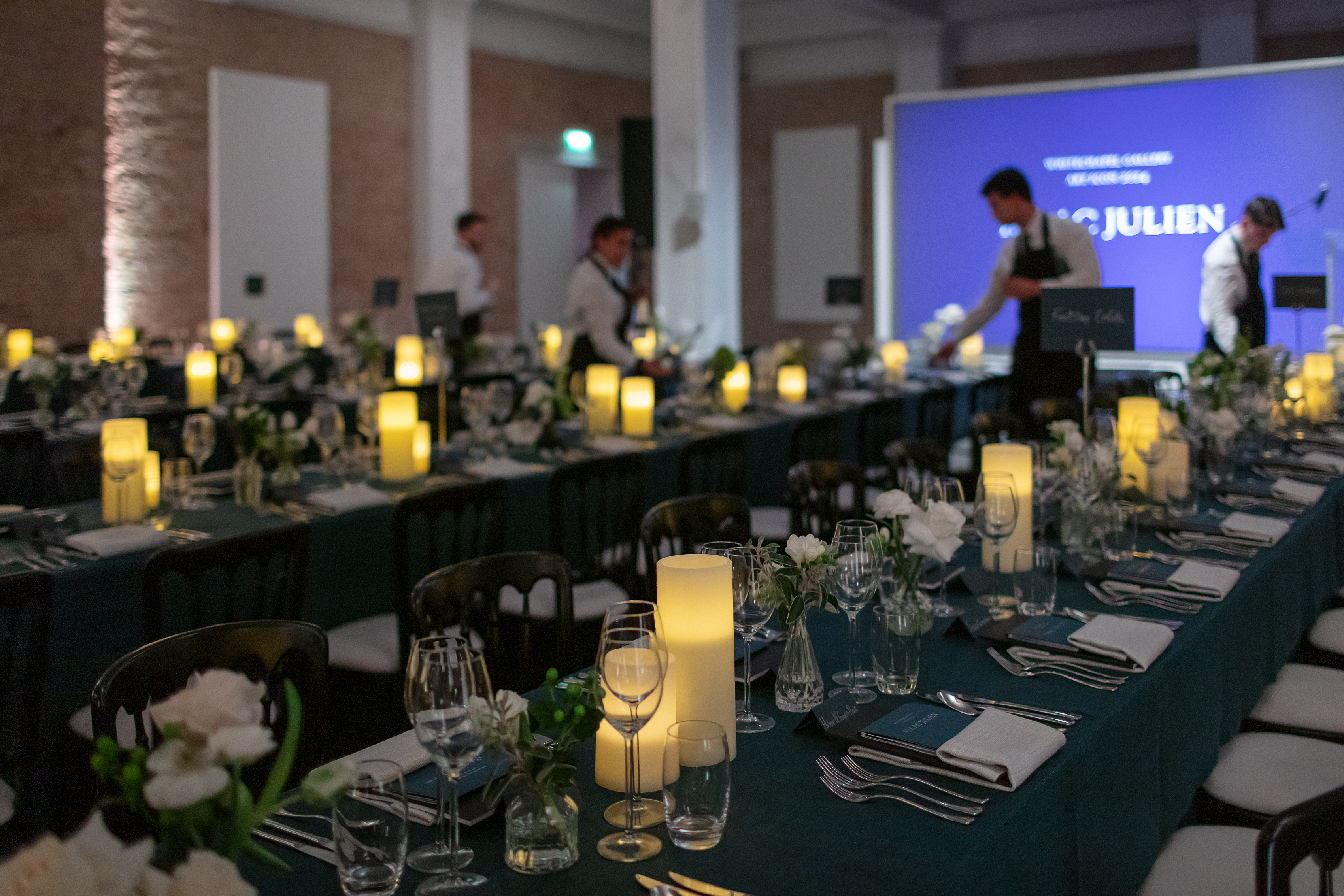 Elegant dining setup with blue linens and white flowers for corporate events in Whitechapel Gallery.