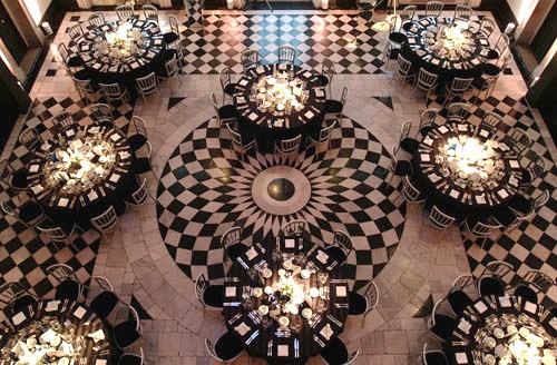 Elegant Great Hall with round tables, ideal for weddings and upscale events.