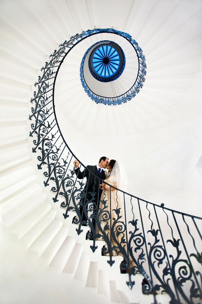 Couple on spiral staircase in The Queen's House, ideal for elegant wedding moments.