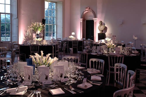 Elegant Great Hall event space with floral centerpieces for galas and corporate dinners.
