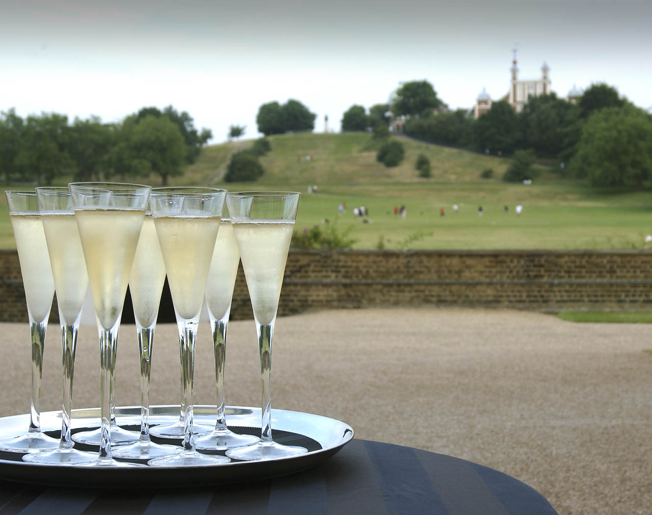 Elegant outdoor event setup with champagne flutes at The Queen's House for weddings and receptions.