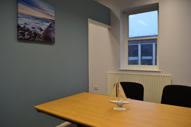 Seaburn Suite meeting room with wooden table, ideal for intimate discussions and brainstorming.
