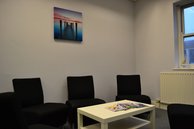 Minimalist Seaburn Suite meeting space with black chairs and white table for brainstorming.
