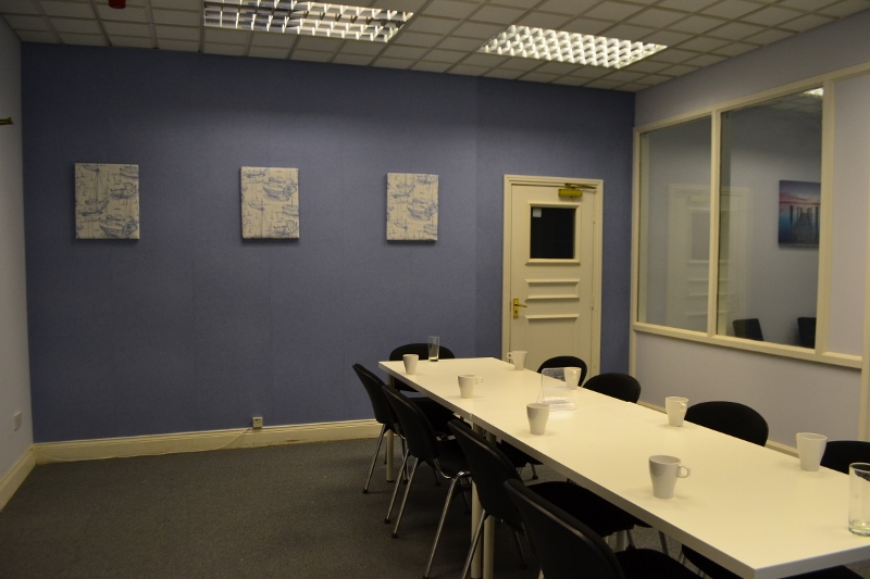 Seaburn Suite meeting room with white table, black chairs, ideal for corporate events.
