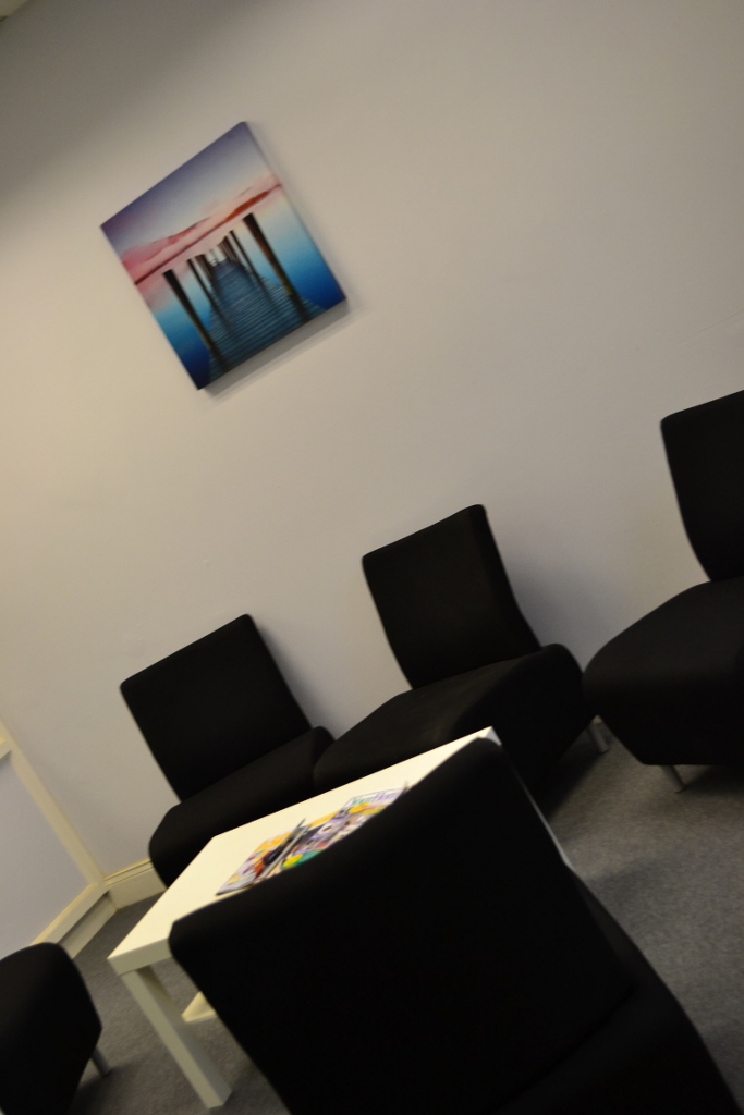 Minimalist meeting space with sleek black chairs for informal discussions and brainstorming.