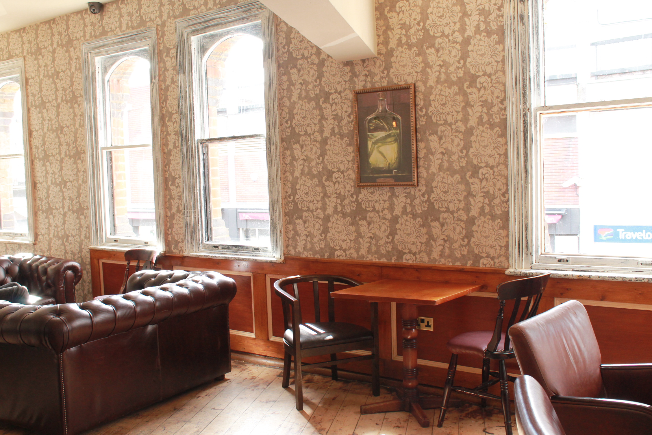 Cozy meeting space with leather seating for informal gatherings at Embrace: The House of Spirits.