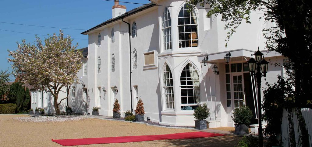 Elegant Banqueting Hall with red carpet, perfect for weddings and corporate events.