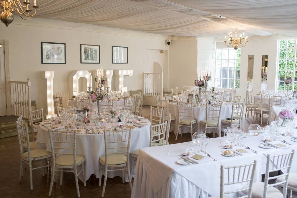 Elegant Banqueting Hall with floral centerpieces for weddings and romantic events.