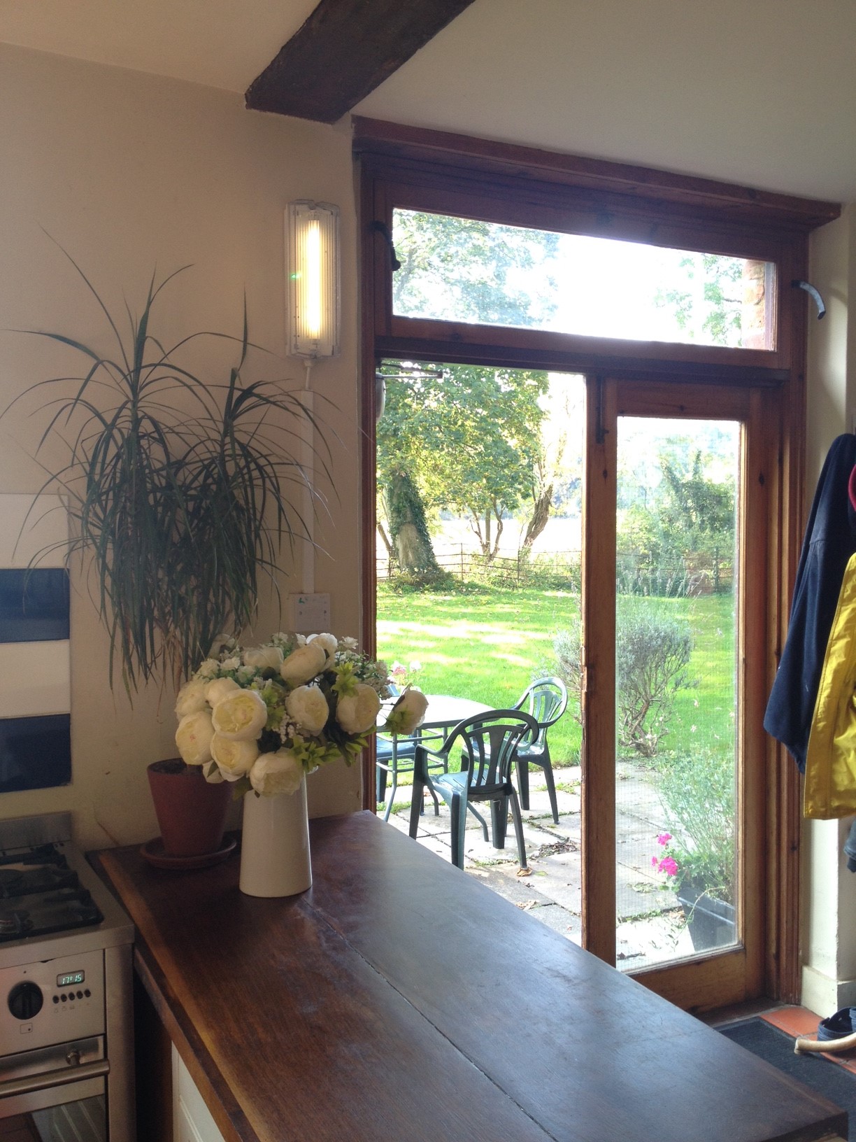 Bright farmhouse kitchen with large windows, ideal for retreats and events.