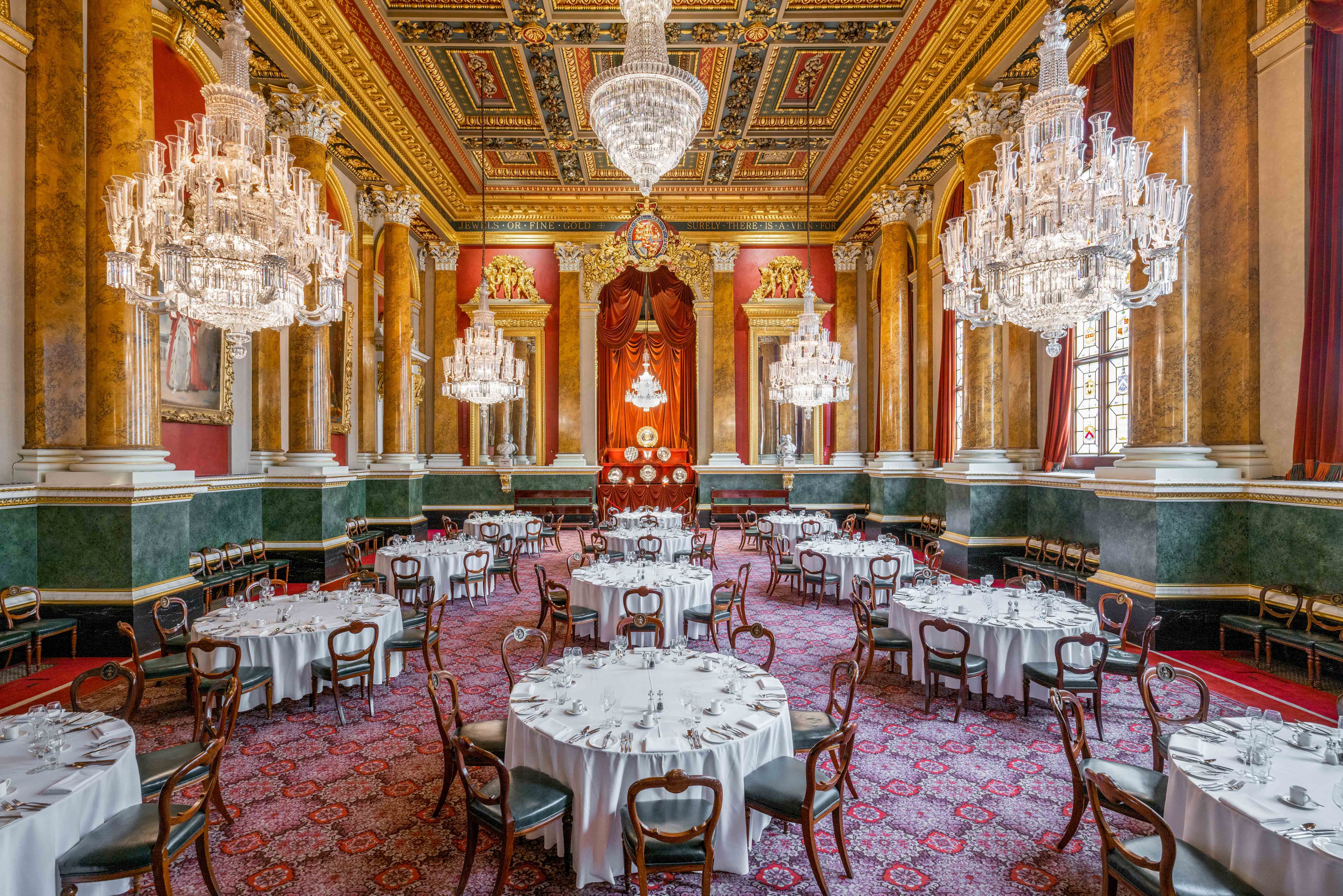 Elegant banquet hall with chandeliers, perfect for corporate events and formal dinners.