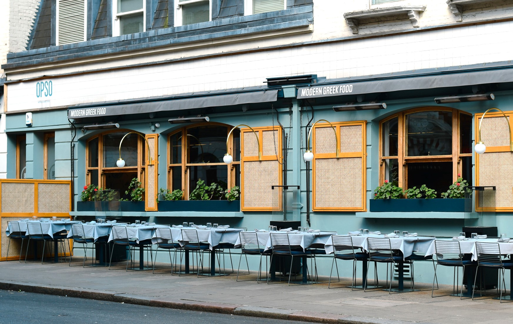 Charming OPSO restaurant exterior with outdoor dining, ideal for networking events.