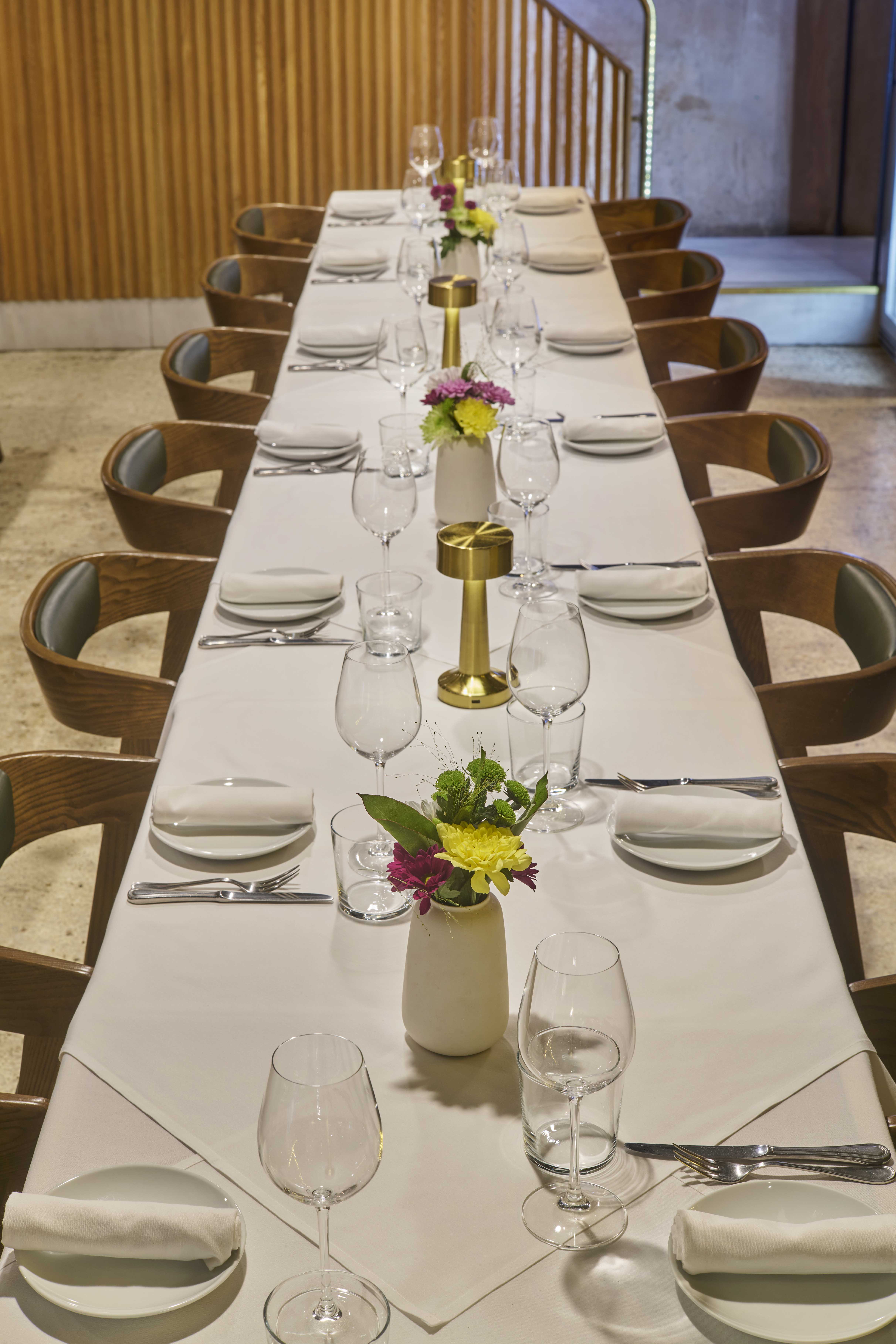 Elegant dining table setup with floral centerpieces for intimate events at OPSO.