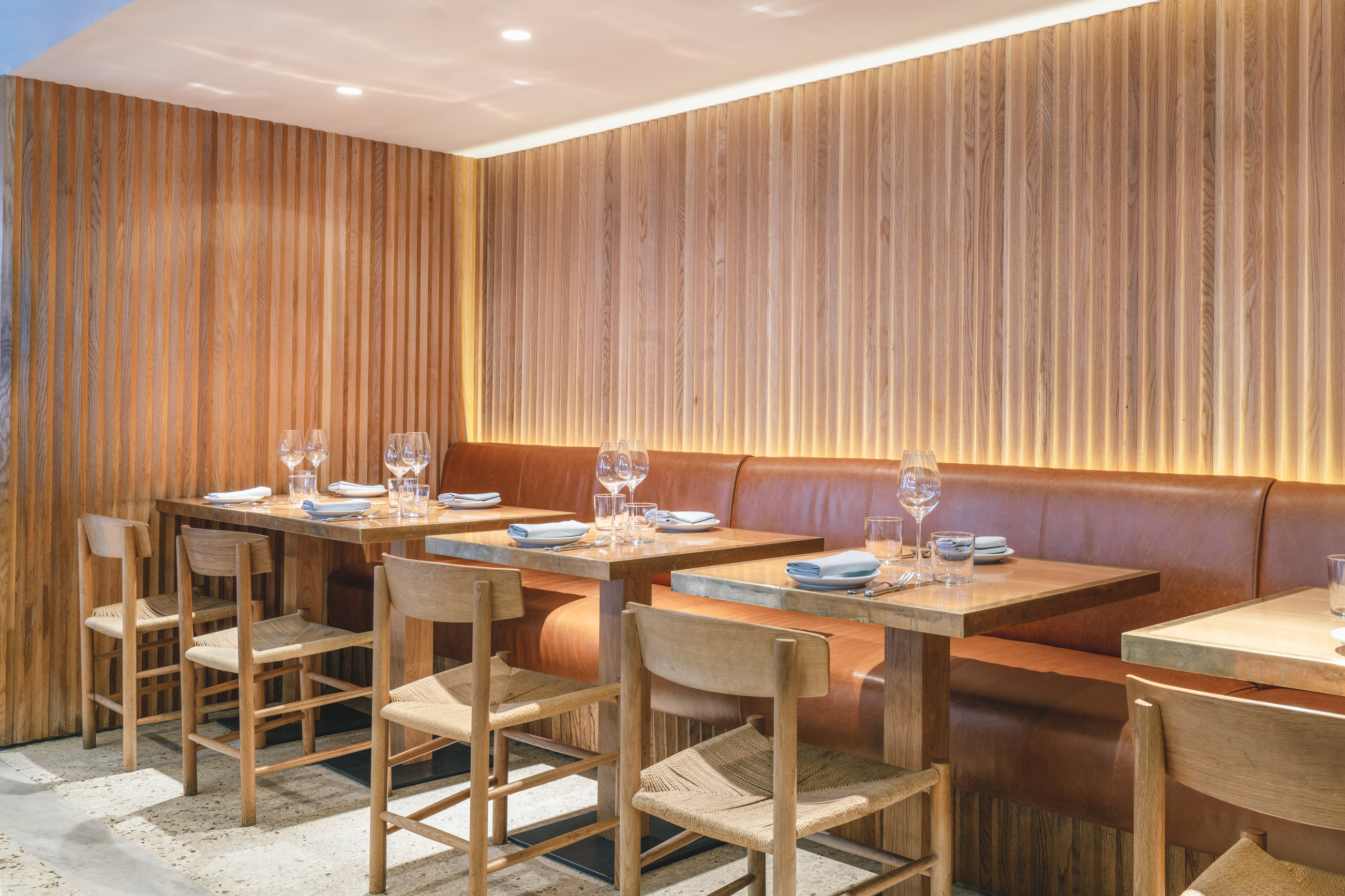 Modern dining room with warm wood accents, ideal for intimate meetings and small events.