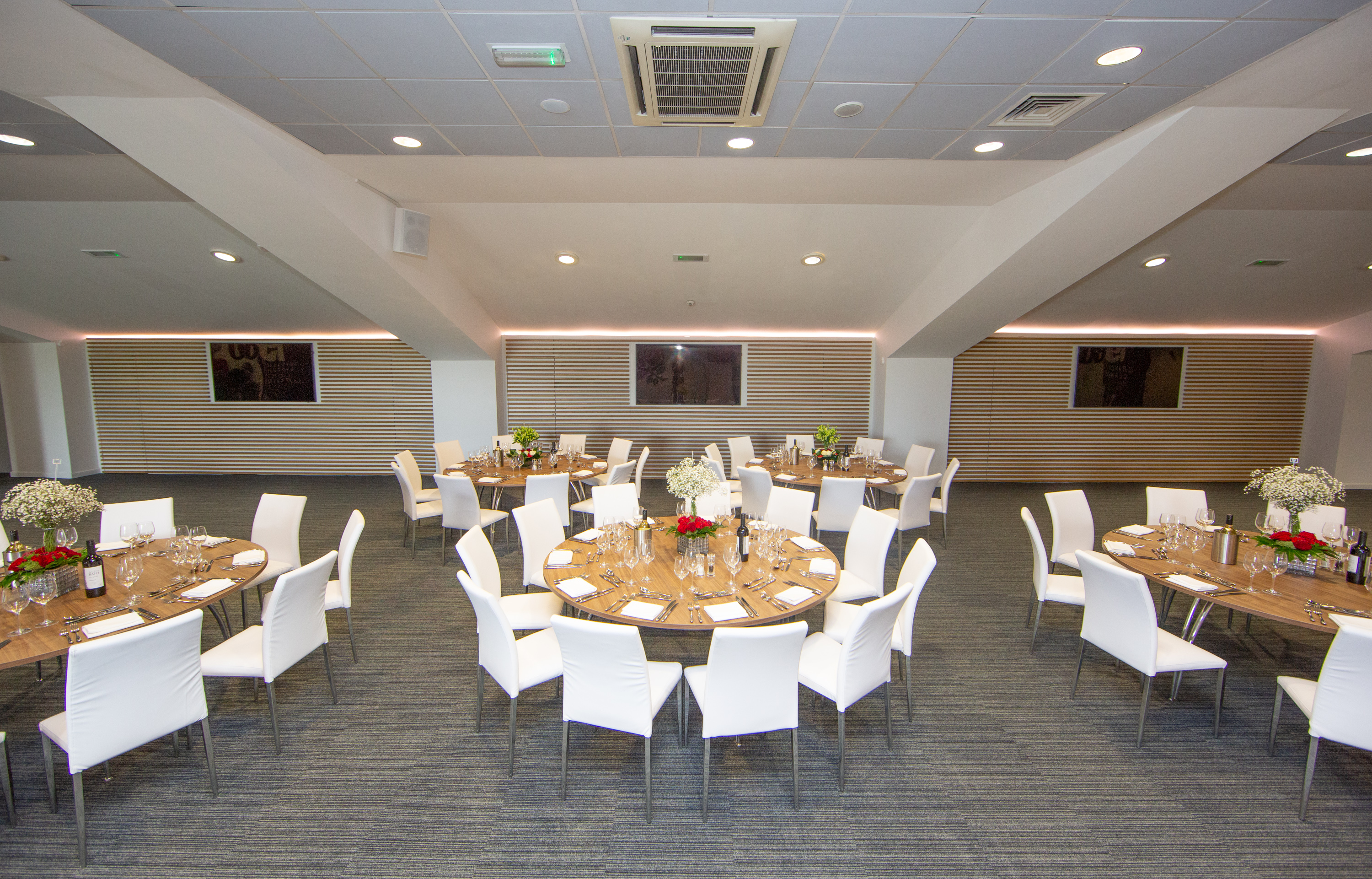 Beaumont event space at Allianz Stadium, Twickenham with floral centerpieces for gatherings.